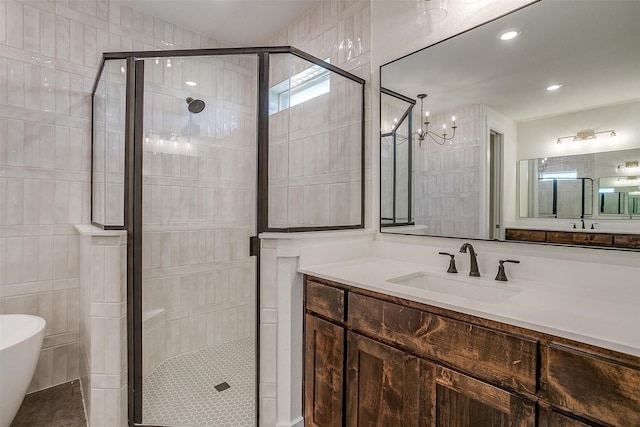 bathroom featuring vanity, plus walk in shower, and tile walls