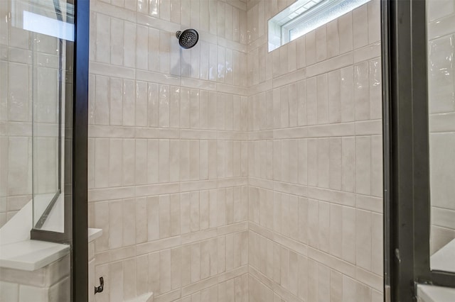 interior details with a tile shower