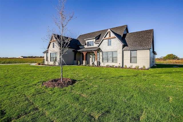 view of front of home with central AC unit and a front yard