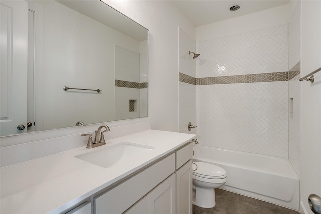 full bathroom with tiled shower / bath, vanity, and toilet