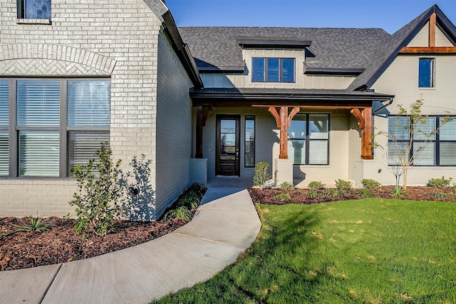 view of exterior entry with a lawn