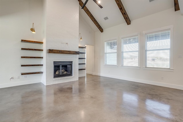 unfurnished living room with beam ceiling, a fireplace, and high vaulted ceiling