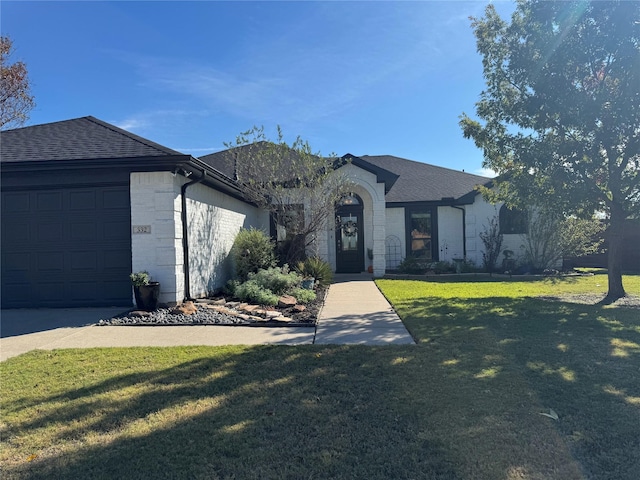 ranch-style house with a front yard and a garage