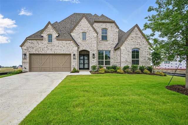 4029 Trellis Dr, Celina, TX 75078 - french country inspired facade featuring brick siding, a front lawn, driveway, and roof with shingles