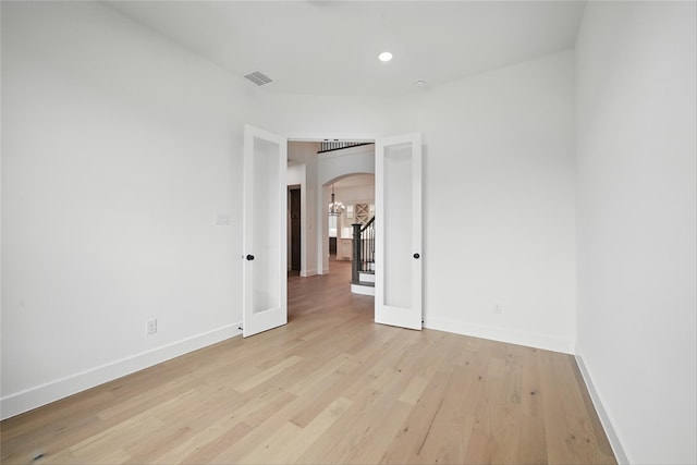 4029 Trellis Dr, Celina, TX 75078 - unfurnished bedroom with arched walkways, light wood-type flooring, baseboards, and recessed lighting