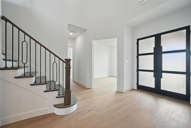 4029 Trellis Dr, Celina, TX 75078 - foyer with french doors, wood finished floors, baseboards, a towering ceiling, and stairway