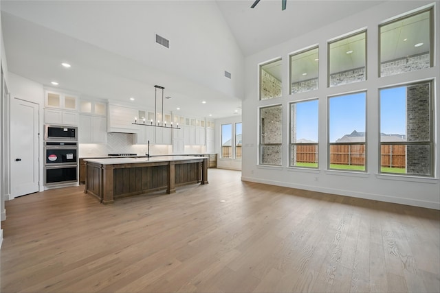 4029 Trellis Dr, Celina, TX 75078 - kitchen featuring stainless steel appliances, a sink, white cabinetry, open floor plan, and recessed lighting