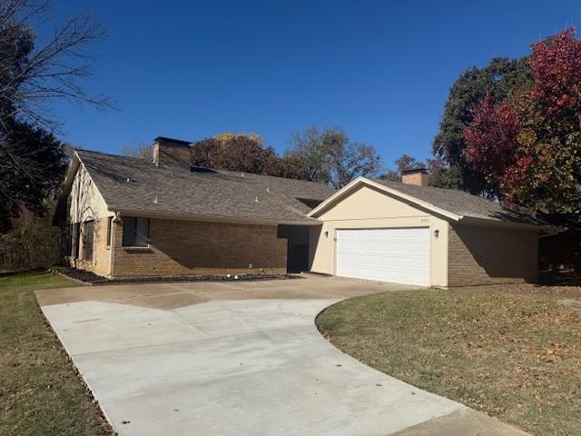 4301 Woodbine St, Flower Mound, TX 75028 - ranch-style home with a garage and a front lawn