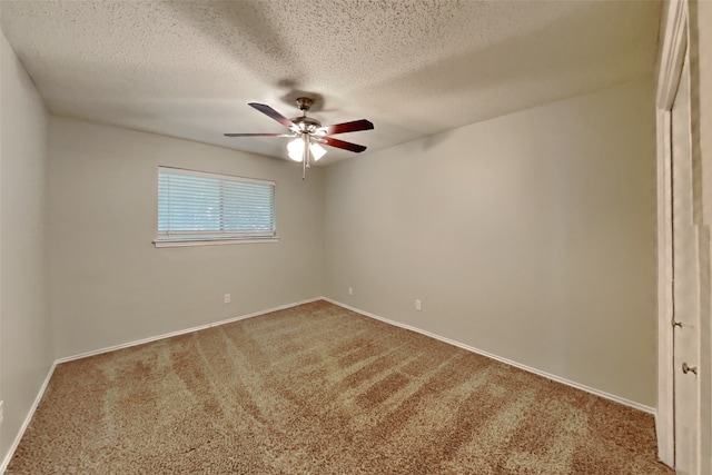 spare room featuring carpet flooring and a textured ceiling