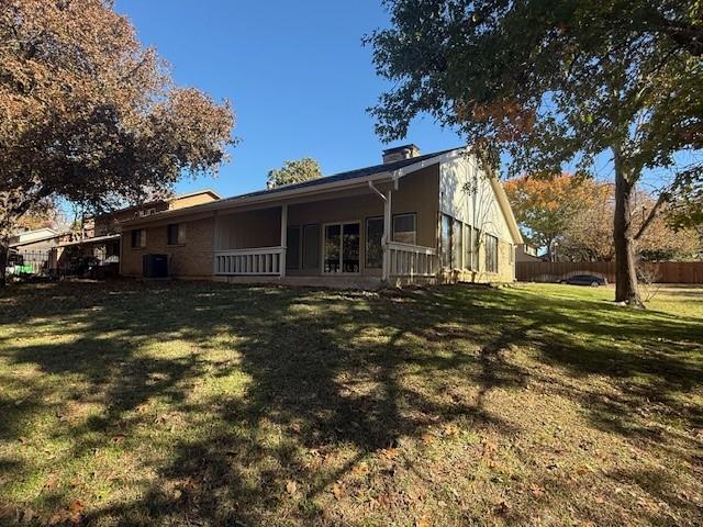 back of house featuring a lawn