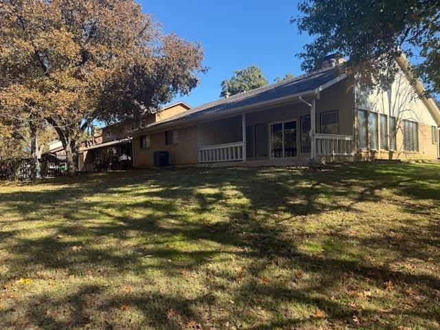 rear view of house featuring a yard