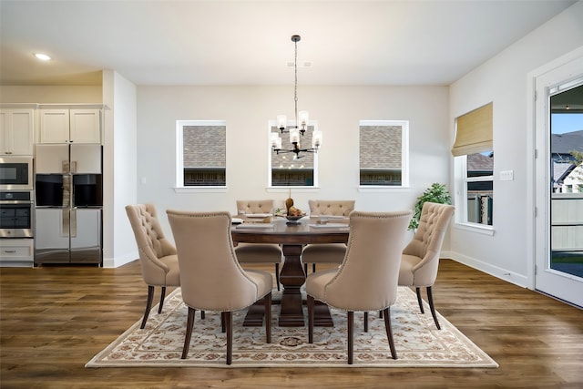 kitchen with white cabinets, stainless steel appliances, dark wood-type flooring, and a center island