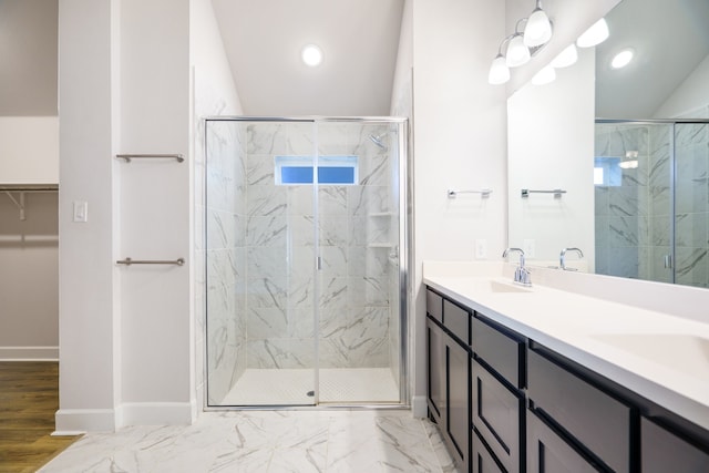 bathroom with vanity, hardwood / wood-style flooring, vaulted ceiling, and a shower with shower door