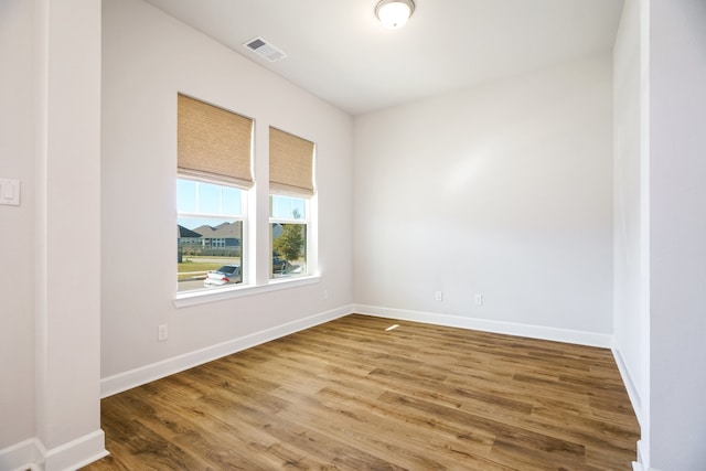 bathroom with toilet and hardwood / wood-style floors