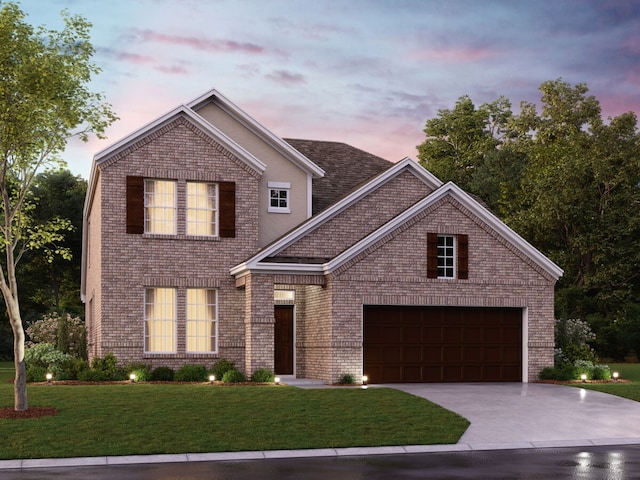 view of front property featuring a garage and a yard