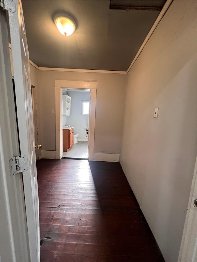 corridor featuring crown molding and hardwood / wood-style flooring