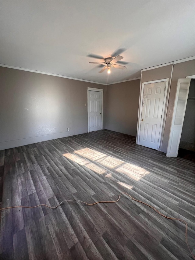 unfurnished bedroom featuring crown molding, ceiling fan, and dark hardwood / wood-style flooring