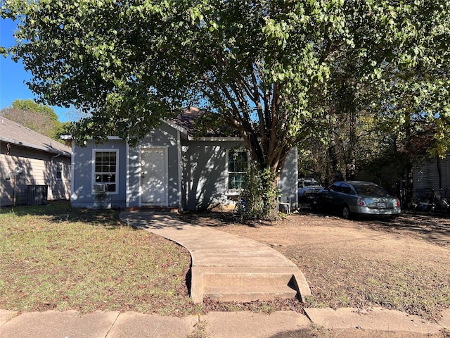 obstructed view of property featuring a front yard