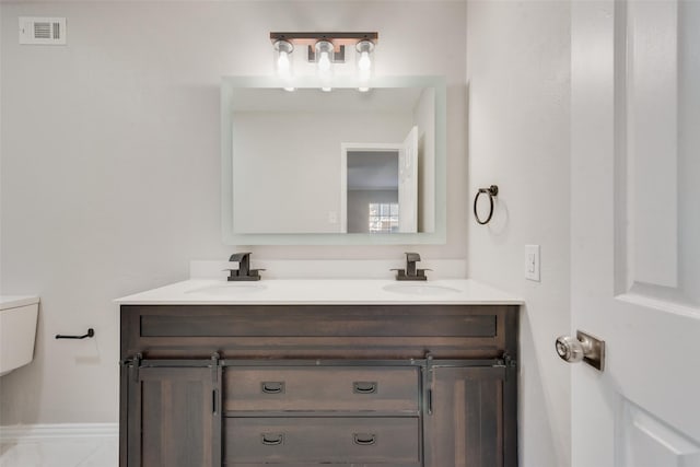 bathroom featuring toilet and vanity