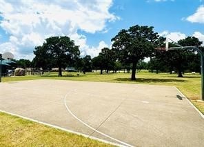 view of sport court featuring a yard