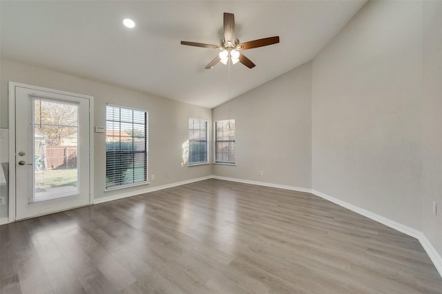 spare room featuring lofted ceiling, hardwood / wood-style flooring, and ceiling fan