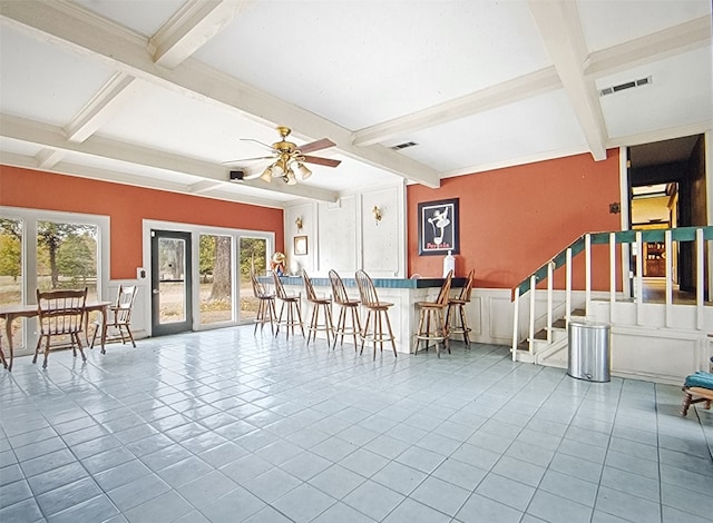 dining room featuring beamed ceiling, ceiling fan, and light tile patterned floors