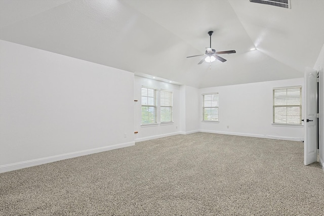 empty room with ceiling fan, lofted ceiling, and carpet