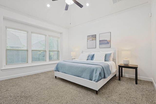 carpeted bedroom with ceiling fan and ornamental molding