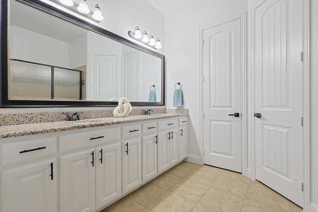 bathroom with vanity, tile patterned floors, and a shower with shower door