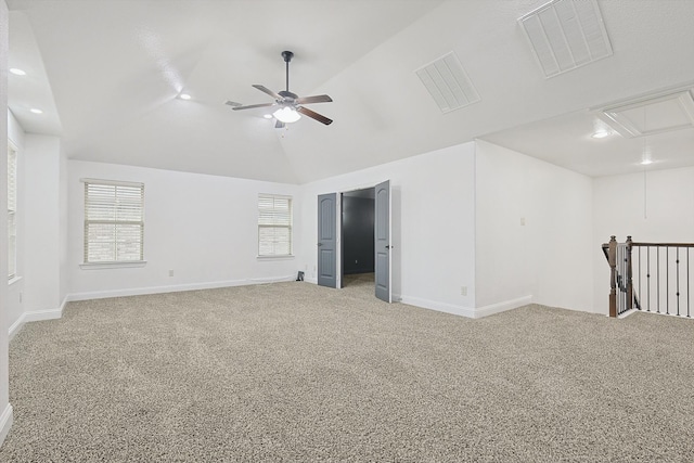 unfurnished room featuring vaulted ceiling, ceiling fan, and carpet floors