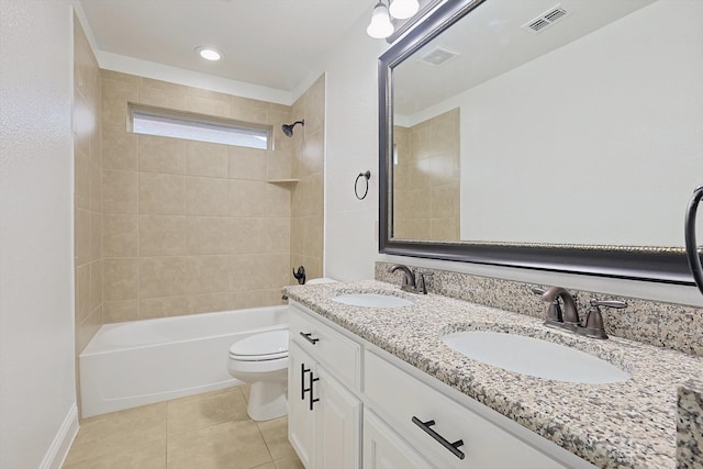 full bathroom with vanity, tile patterned flooring, toilet, and tiled shower / bath combo