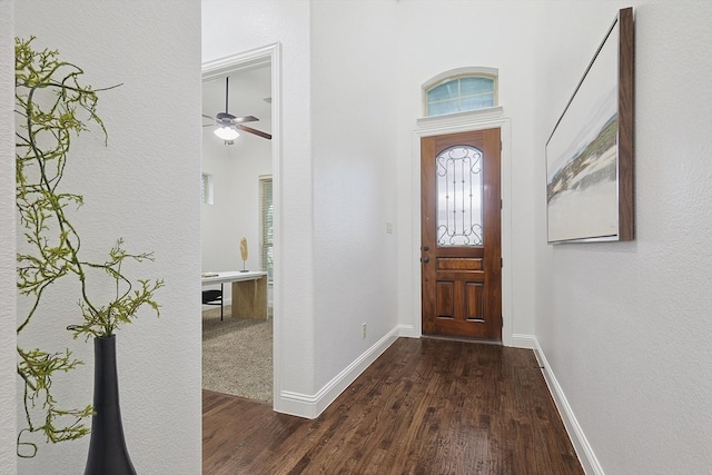 foyer entrance with dark wood-type flooring and ceiling fan