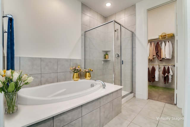 bathroom with tile patterned flooring and separate shower and tub