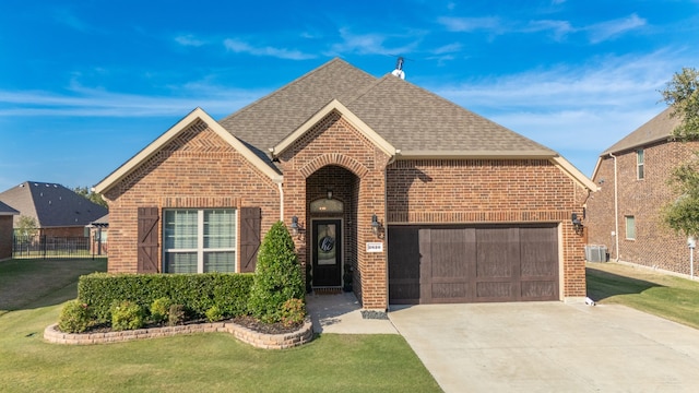 front of property featuring central AC unit and a front lawn