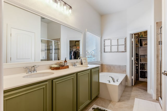 bathroom featuring tile patterned flooring, shower with separate bathtub, and vanity