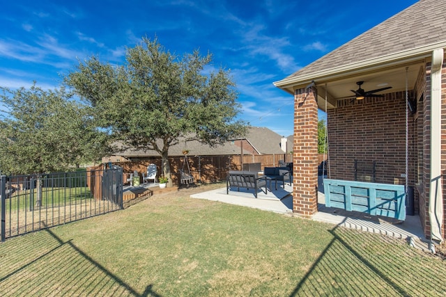 view of yard featuring ceiling fan and a patio