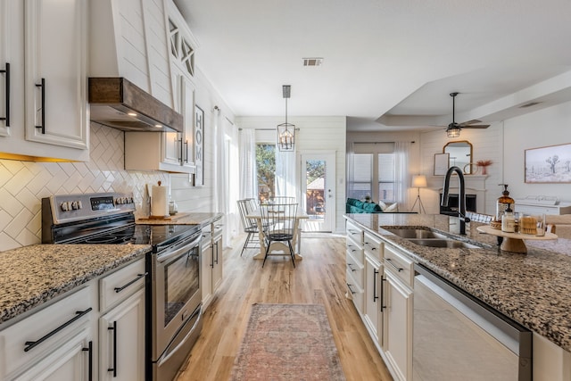 kitchen with white cabinetry, appliances with stainless steel finishes, and sink