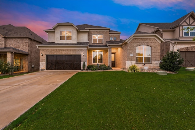 view of front of house with a garage and a lawn