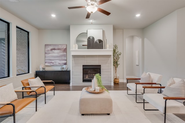 living room with a fireplace, hardwood / wood-style flooring, and ceiling fan