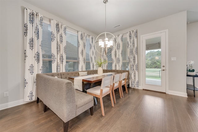 dining room featuring dark hardwood / wood-style floors and an inviting chandelier