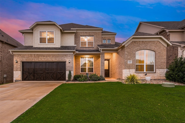 view of front of home featuring a garage and a lawn