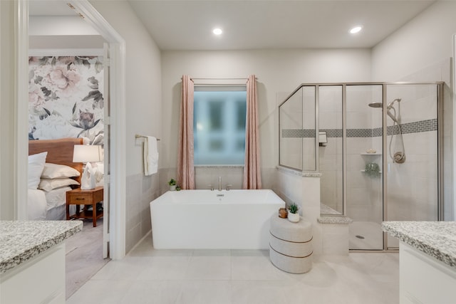 bathroom with tile patterned flooring, vanity, and independent shower and bath