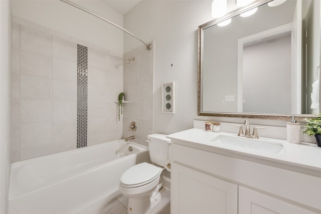 full bathroom with vanity, tiled shower / bath combo, and toilet