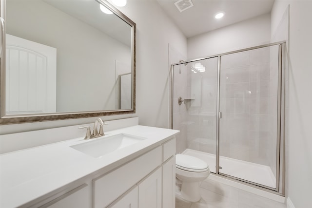 bathroom with tile patterned floors, vanity, toilet, and a shower with door