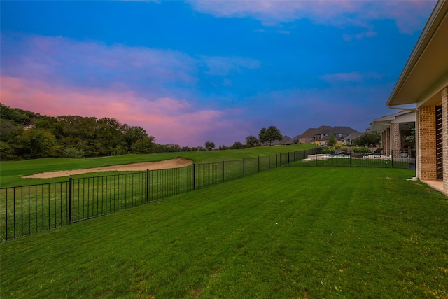 view of yard at dusk