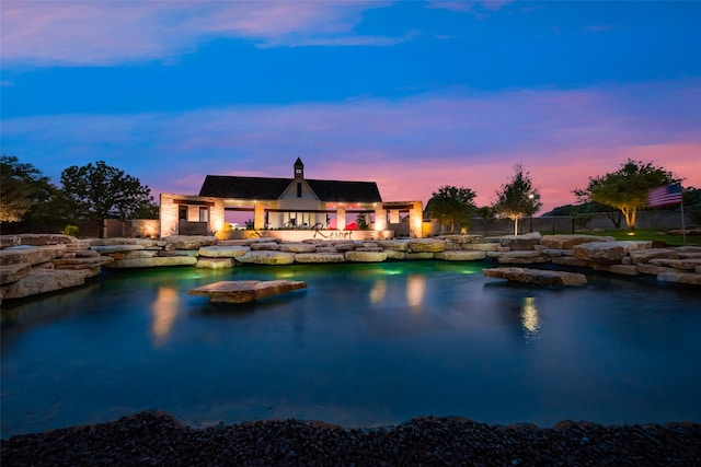 view of pool at dusk