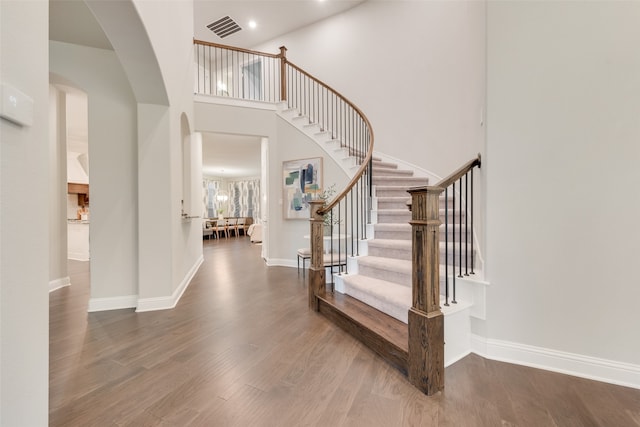 entrance foyer with hardwood / wood-style flooring and a high ceiling