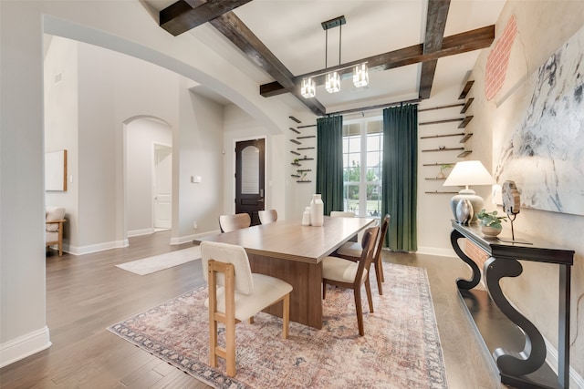 dining area with hardwood / wood-style flooring and beam ceiling