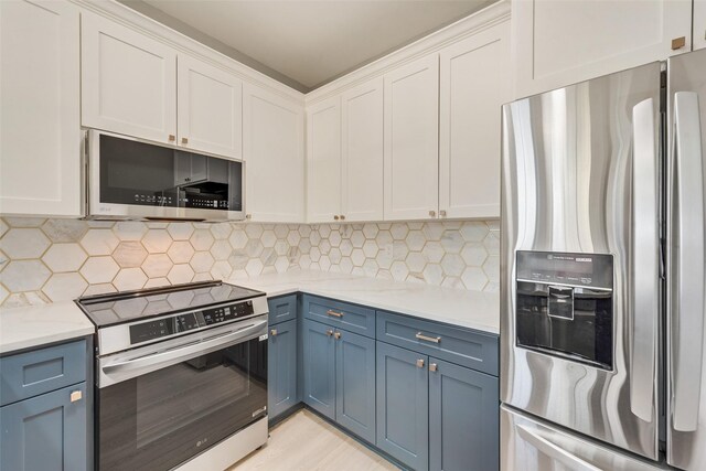 kitchen with blue cabinetry, stainless steel appliances, white cabinetry, and tasteful backsplash