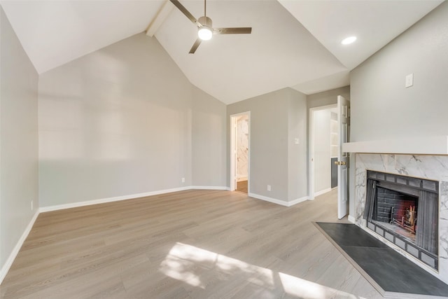 209 Cimarron Trl Unit 6, Irving, TX 75063 - unfurnished living room with a ceiling fan, high vaulted ceiling, a premium fireplace, light wood-style flooring, and baseboards